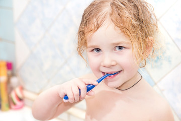 Little girl washing teeth after bath