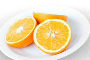 Sliced fresh orange fruit on a white plate