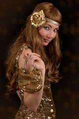 Retro-styled woman in golden dress
