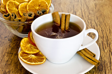 Cup of orange tea with cinnamon