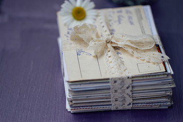 stack of old letters with chamomile