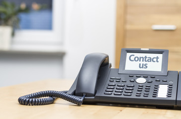 telephone with digital display on wooden desk