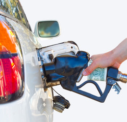 A hand fueling white car.