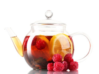 Glass black fruit tea in glass teapot isolated on white