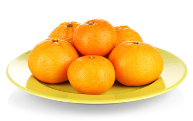 Tasty mandarines  on color plate isolated on white