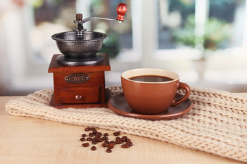 cup of coffee with scarf on table in room