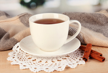 cup of tea with scarf on table in room