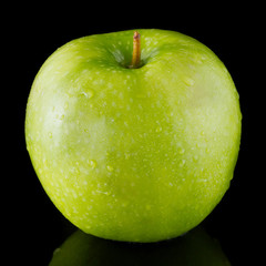 Green apple isolated on a black background
