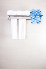 bathroom accessory clean towels and blue flip-flop