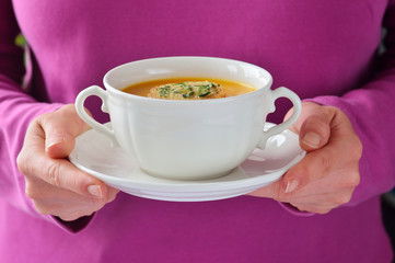 Homemade roasted-pumpkin soup in a white bowl.
