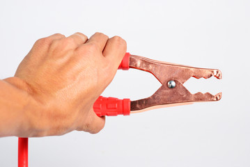 Hand with red battery extension cable