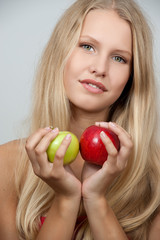 Bright spring portrait of happy healthy woman holding apple