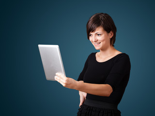 Young woman looking at modern tablet