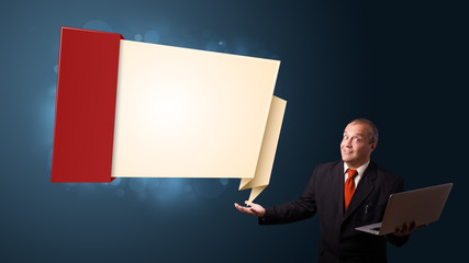 Businessman holding a laptop and presenting modern origami copy