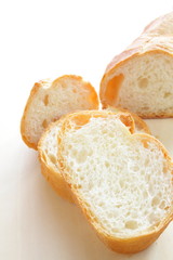 french bread, sliced baguette on wooden table