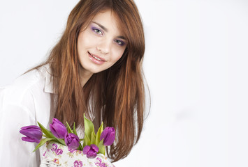 Fototapeta premium Beautiful girl with bunch of spring flowers