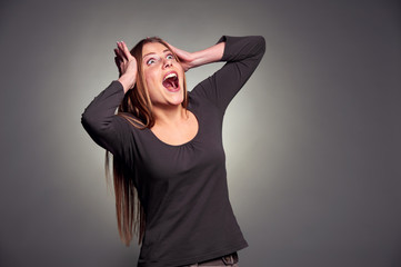 shocked young woman looking up