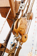 Ropes and wooden tackle blocks  of an sailing vessel © Igor Sokolov