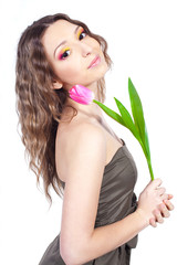 Naklejka premium young woman with bouquet of flowers over white background