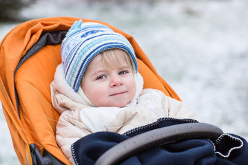 Little  boy one year old in warm winter clothes