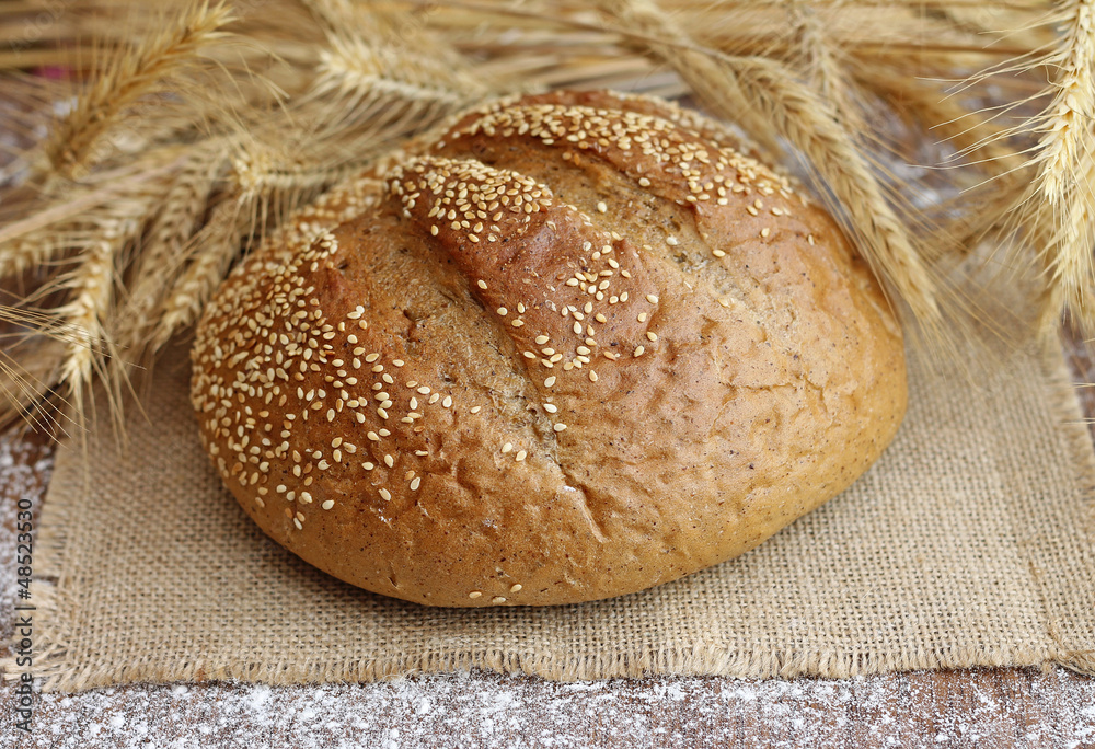 Wall mural tasty bread with spikelets, close-up