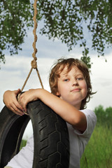 happy boy on swing outdoors