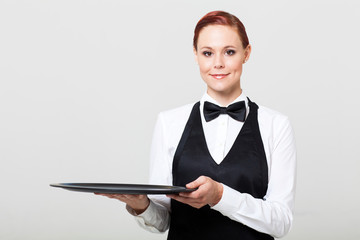 pretty waitress holding an empty tray
