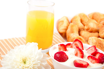 Breakfast: croissants, strawberries with cream, orange juice
