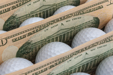 The white golf balls between American dollars banknotes