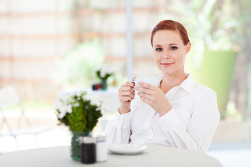 attractive young woman having coffee in cafe