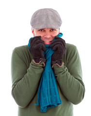 Young man with gloves and scarf  shivering  from cold