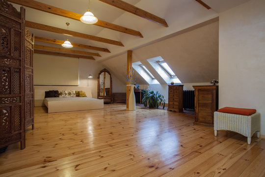 Cloudy home - attic with a pine wood floor