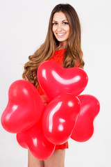 Valentines day woman holding red heart balloons