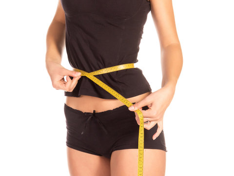 Woman measuring her waist. Healthy lifestyles concept