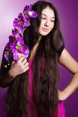 young beautiful girl with long hair and orchid