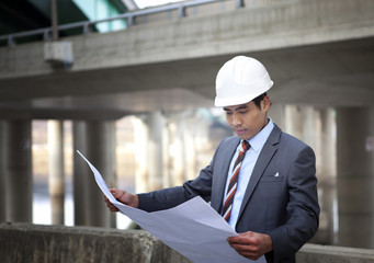 asian architect on highway construction site