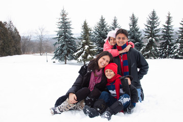 East Indian family playing in the snow