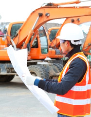 Fototapeta premium road construction worker in front of excavator