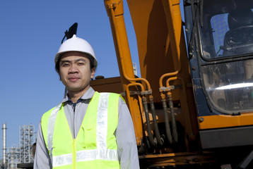 portrait construction worker standing front of heavy equipment