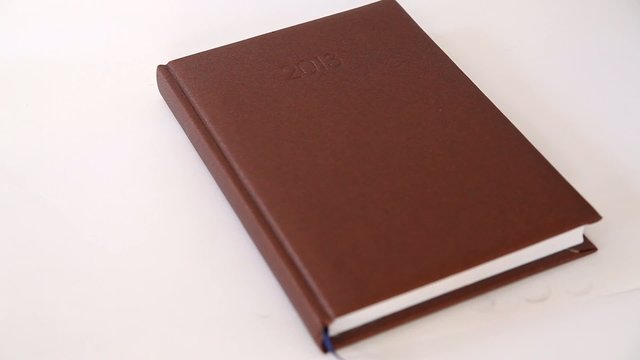 Man writing information in agenda book