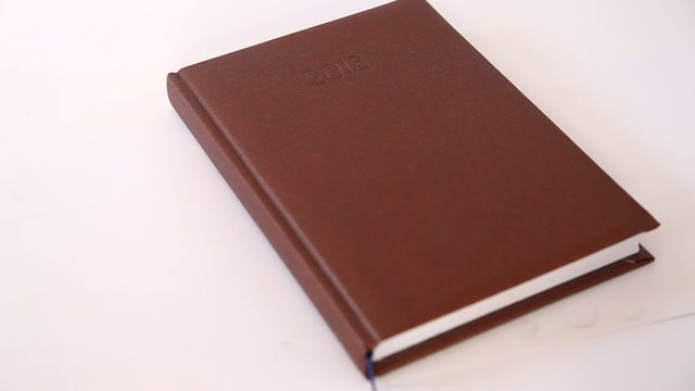 Man writing information in agenda book
