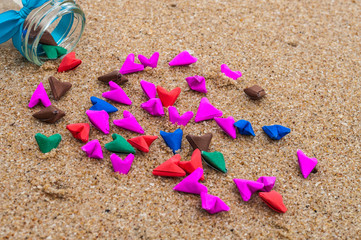 Paper hearts in a glass bottle.