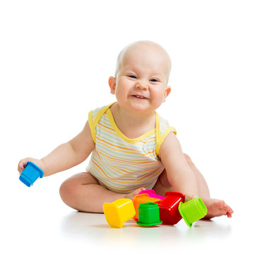Funny little child is playing with toys isolated over white