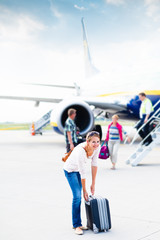 Just arrived: young woman at an airport having just left the air