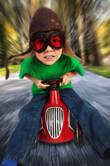 Boy on toy racing car