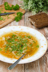 chicken soup with noodles and carrots vertical