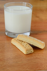 Milk and shortbread biscuits on a wooden background