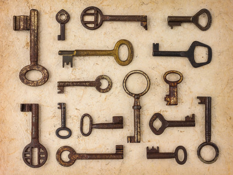 Different antique keys on a retro paper background