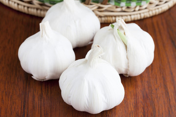 Four Garlic on a dark wooden table