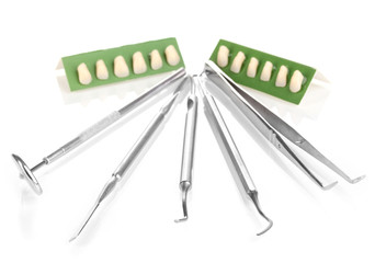 denture with dental tools isolated on white